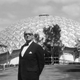 Buckminster Fuller stands in front of the geodesic dome building at the American National Exhibition in Moscow in 1959.